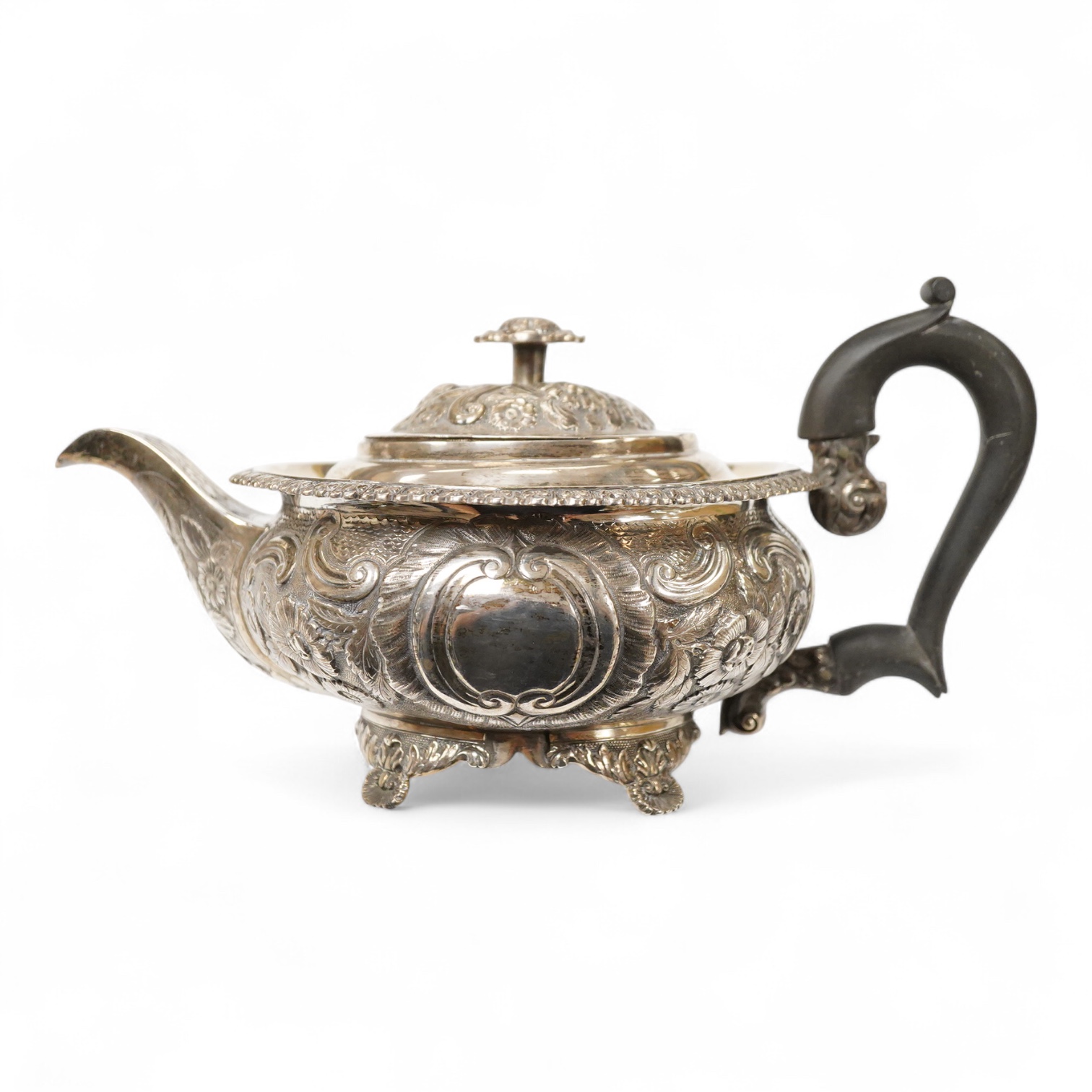 A late George III silver circular teapot, by Samuel Hennell, London, 1818, with later embossed decoration, gross weight 26.9oz.